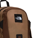 A close-up of a brown and tan backpack from The North Face, featuring a black square logo patch with white text on the front.
