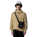 Person wearing a beige hoodie with a logo, carrying a black crossbody bag on a white background