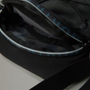 Close-up of a black bag with a zipper, showing the brand name 'C.P. Company'.