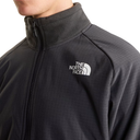 Close-up of a person wearing a dark gray The North Face zip-up fleece jacket, showing the white embroidered logo on the chest.