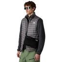 Man wearing a gray puffer vest, black shirt, green pants, and sunglasses on a white background