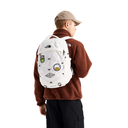 A person shown from the back wearing a brown fleece jacket, beige cap, and black pants, carrying a white The North Face backpack decorated with multiple colorful patches, against a solid white background.