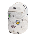 The North Face Cream backpack with multiple brand patches, shown on a solid white background.