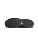 The black rubber outsole of a shoe, showing deep tread patterns and a small pink logo for The North Face on a white background.