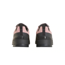 A pair of low-top sneakers shown from the back, featuring a light pink upper with black overlays, pull tabs, and thick black soles. The embossed logo on the heel reads 'THE NORTH FACE'.