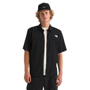 Person wearing a black shirt with a logo and a black cap on a white background