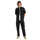 Person wearing a black shirt and pants with a white logo on a white background