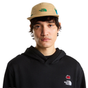 Person wearing a black hoodie and beige cap with The North Face logo on a white background