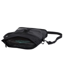 A black nylon crossbody bag shown from a side angle with its front zippered pocket open, revealing a dark green item inside. The bag features a black adjustable shoulder strap and a small white logo on the upper left of the pocket.