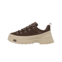 A single low-top sneaker shown in profile against a solid white background. The shoe features a dark brown suede upper with matching brown laces, a thick beige midsole, and a beige outsole.