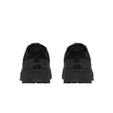 Black low-top sneakers shown from the rear, featuring a thick black sole and a small embossed logo on the heel, set against a plain white background.