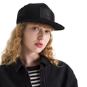 Person wearing a black cap with a logo on a white background