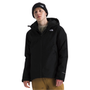 A man wearing a black The North Face hooded jacket, a black beanie, and tan pants, standing against a solid white background.