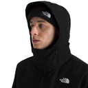 A man wearing a black The North Face hooded jacket and matching black beanie, shown in a close-up profile shot against a plain white background.