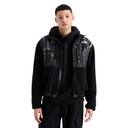 A model wearing a black zip-up The North Face hoodie jacket with black and white marble-patterned shoulder panels, layered over a black hoodie and black cargo pants, against a plain white background.