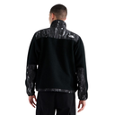 A man viewed from the back wearing a black fleece pullover jacket with a white marbled pattern on the shoulders and sleeves, featuring a small white The North Face logo on the upper right.