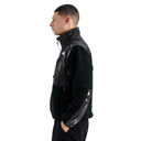 A man shown in profile wearing a black fleece jacket with glossy, textured black panels on the chest and sleeves, set against a plain white background.