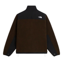 The back view of a brown and black fleece jacket by The North Face, featuring a solid brown body, black shoulder yokes and sleeve panels, and a small white logo on the upper back.