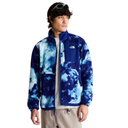 A model wearing a blue and white tie-dye fleece jacket by The North Face, styled over a white t-shirt and beige pants against a solid white background.