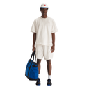 Person wearing a white outfit with a blue bag on a white background