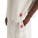 White mesh shorts with red logo patches on a white background