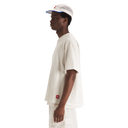 Person wearing a white outfit with a cap on a white background