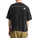 Person wearing a black t-shirt with a logo on the back, standing against a white background