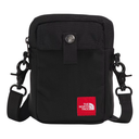 A black nylon crossbody bag by The North Face, featuring a front flap pocket with a snap button closure, a red brand patch, and a detachable shoulder strap with black clips, shown on a plain white background.