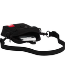 A black nylon crossbody camera bag with an adjustable webbing strap, shown with a silver camera partially tucked inside. A red rectangular brand patch is visible on the upper left of the bag.
