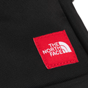 Close-up of a black woven fabric item featuring a red square patch with white embroidered 'THE NORTH FACE' branding.