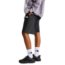 Person wearing a gray jacket, black shorts, and white socks with a brand logo on a light gray background