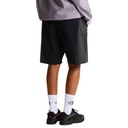 Person wearing black shorts and white socks with a brand logo on a white background