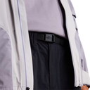 Close-up of a person wearing a gray jacket with a black belt, featuring The North Face logo.