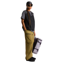 Person wearing a black cap, sunglasses, gray shirt, and green pants holding a backpack on a white background