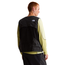 Person wearing a black and green jacket with a visible brand logo on a white background