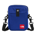 A blue canvas crossbody phone bag with black straps and hardware, featuring a red 'The North Face' logo patch on the front.