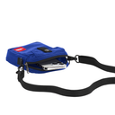 A royal blue fabric phone pouch with a black adjustable shoulder strap, shown with a silver smartphone tucked inside. The pouch features a red and white logo patch on the front.