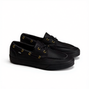 A pair of black leather boat shoes with gold-tone grommets and laces, displayed on a clean white background.