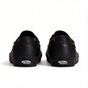 A pair of black Vans platform sneakers shown from the back, featuring a thick black sole and the signature Vans logo on the heel.