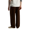 A person wearing wide-leg brown checkered pants, a white t-shirt, and leopard-print sneakers, shown from the waist down against a plain white background.