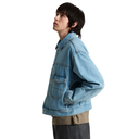 A model shown in profile wearing a light blue denim jacket over a beige shirt and dark gray pants, photographed against a solid white background.