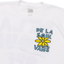 White Vans crewneck t-shirt featuring a yellow flower and blue 'DE LA SOUL VANS' graphic on the chest.