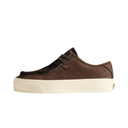 A brown suede low-top sneaker with a textured dark pattern on the toe cap and a thick cream-colored platform sole, shown from a side profile on a white background.