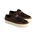 A pair of low-top slip-on shoes with dark brown and black camouflage-patterned uppers, brown laces, and thick cream-colored platform soles, shown against a plain white background.