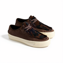 A pair of low-top platform sneakers in dark brown and black camouflage print, featuring perforated suede panels, matching laces, and thick cream-colored rubber soles, photographed on a clean white background.