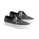 A pair of Vans platform sneakers in dark gray washed canvas with white laces and white rubber soles, decorated with small white studs on the toe box.