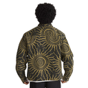 A person shown from the back wearing a long-sleeve jacket with a bold sunburst and spiral pattern in tan and black, photographed against a plain white background.