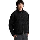 A model wearing a black textured zip-up jacket over a black shirt and gray pants, photographed against a solid white background.