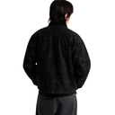 A person shown from the back wearing a black textured jacket and dark gray pants against a plain white background.