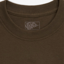 Close-up of a brown sweatshirt with a Vans logo on the chest.